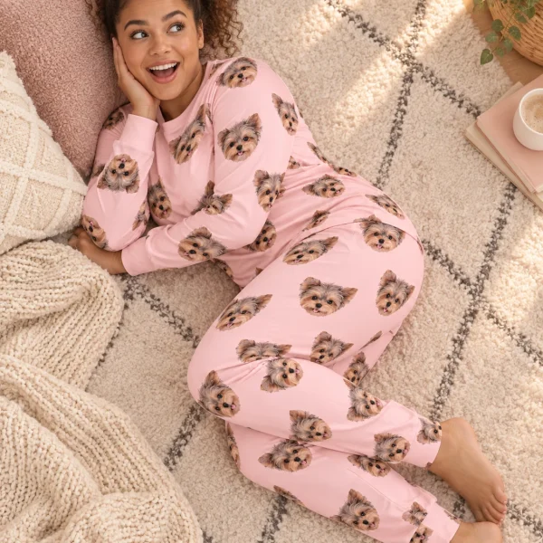 Woman sitting in birthday pajamas covered in Yorkshire terrier faces — MyDogPics