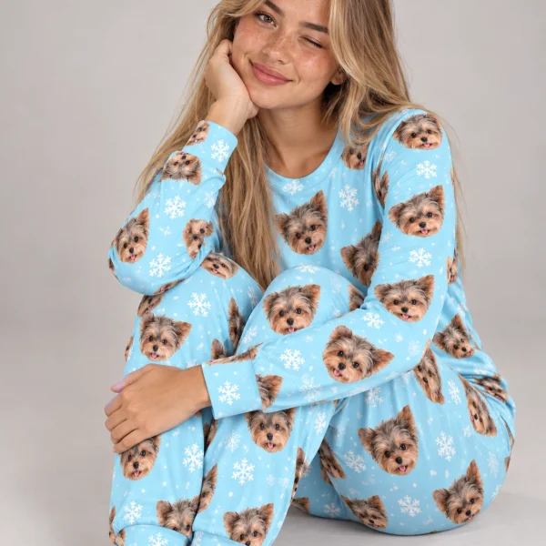 Woman sitting in birthday pajamas covered in Yorkshire terrier faces — MyDogPics