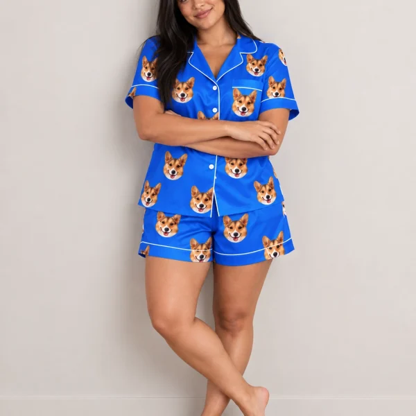 Woman wearing bridal pajamas covered in tan-and-white corgi faces on royal blue satin — MyDogPics