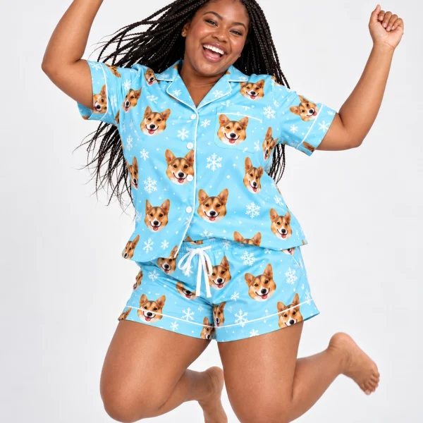 Woman posing in bridal party pajamas, tan-and-white corgi faces on light blue snowflake satin — MyDogPics