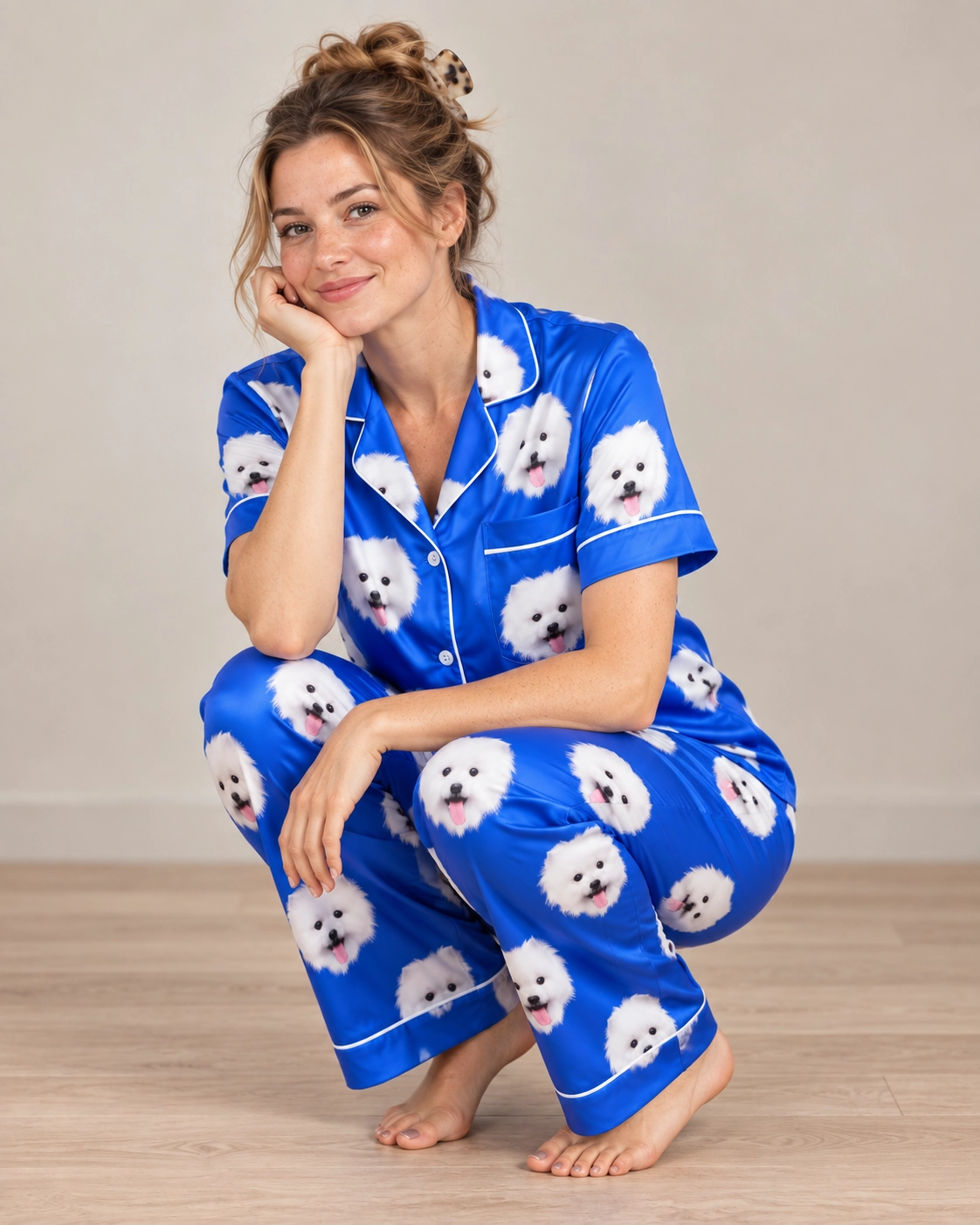 Button Up Pajama Set – Pose, Royal Blue | MyDogPics Woman posing in a button up pajama set, white Pomeranian faces on royal blue satin — MyDogPics