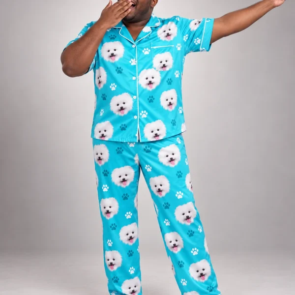 Man posing in a button up pajama set, white Pomeranian faces on teal paw-print satin — MyDogPics