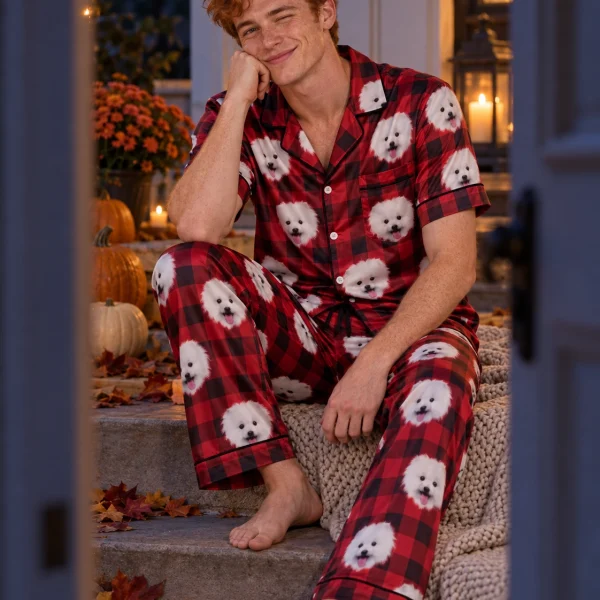 Man sitting in a button up pajama set covered in white Pomeranian faces — MyDogPics