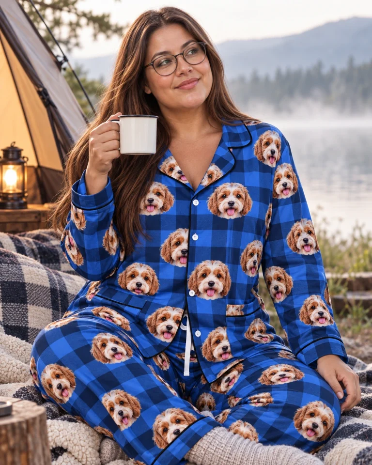 Woman sitting in classic pajamas covered in doodle puppy faces — MyDogPics