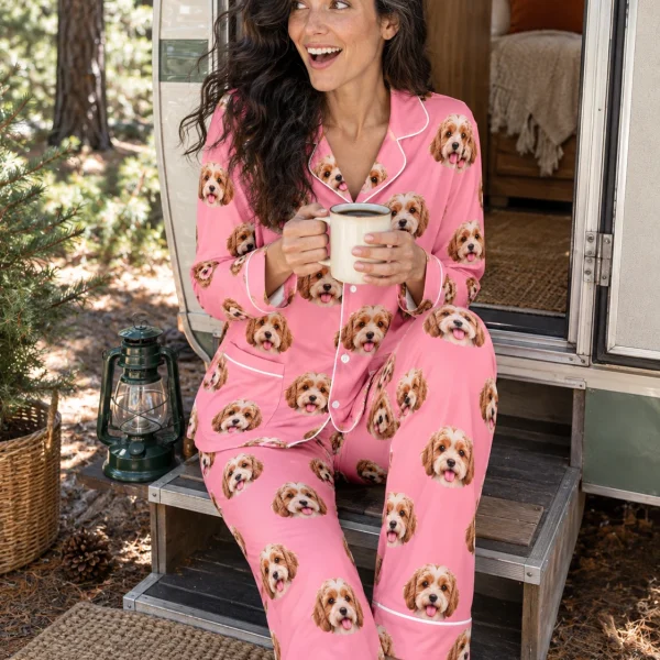 Woman sitting in classic pajamas covered in doodle puppy faces — MyDogPics