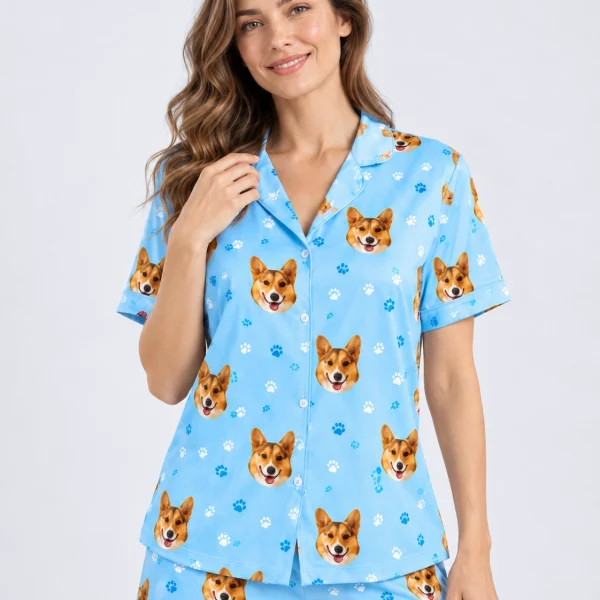 Close-up of the corgi pajamas print: corgi faces on sky blue satin with paw prints — MyDogPics
