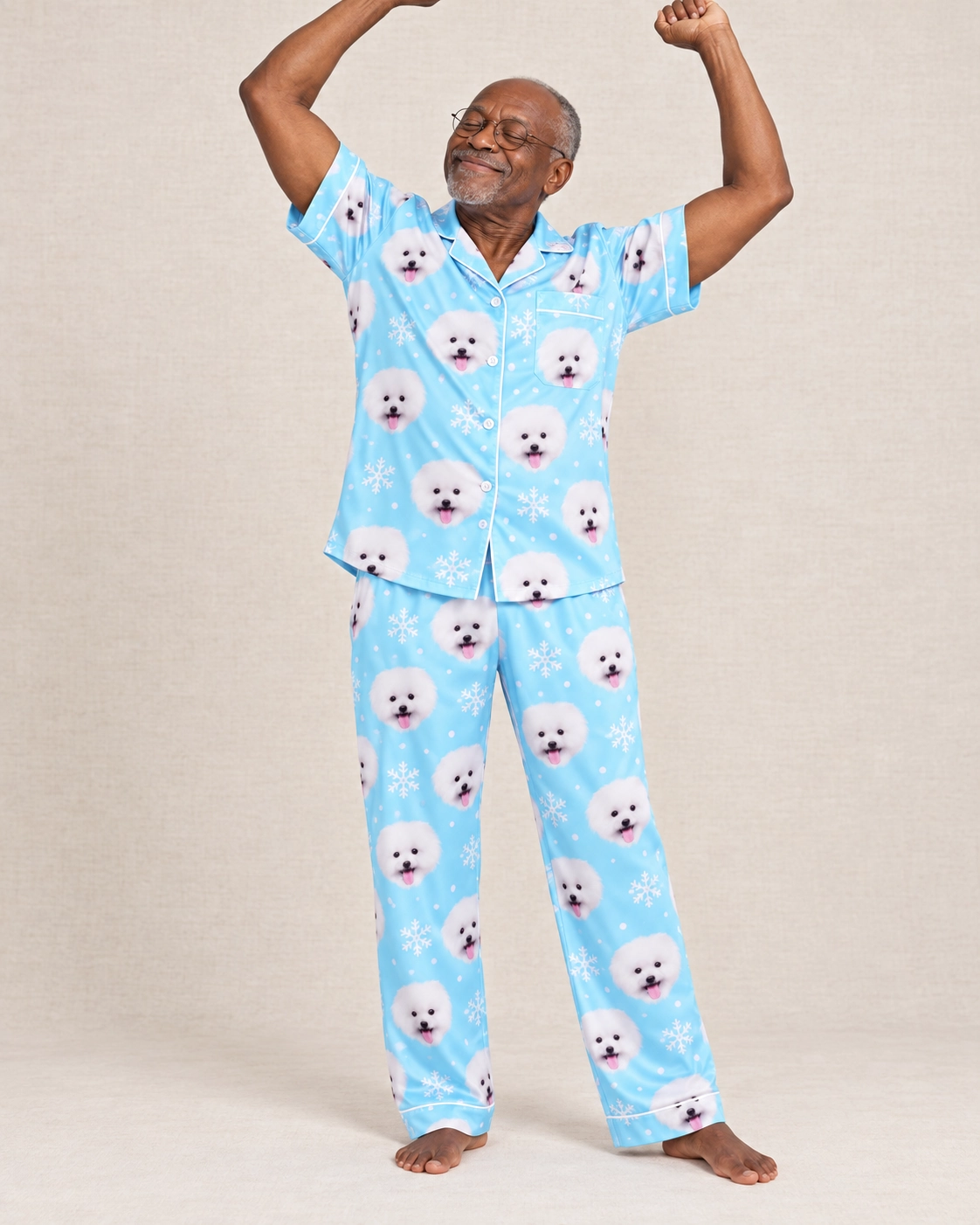 Couples Christmas Pajamas – Pose, Light Blue Snowflake | MyDogPics Man posing in couples Christmas pajamas, white Pomeranian faces on light blue snowflake satin — MyDogPics