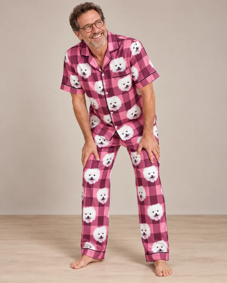 Man posing in couples Christmas pajamas, white Pomeranian faces on pink plaid satin — MyDogPics