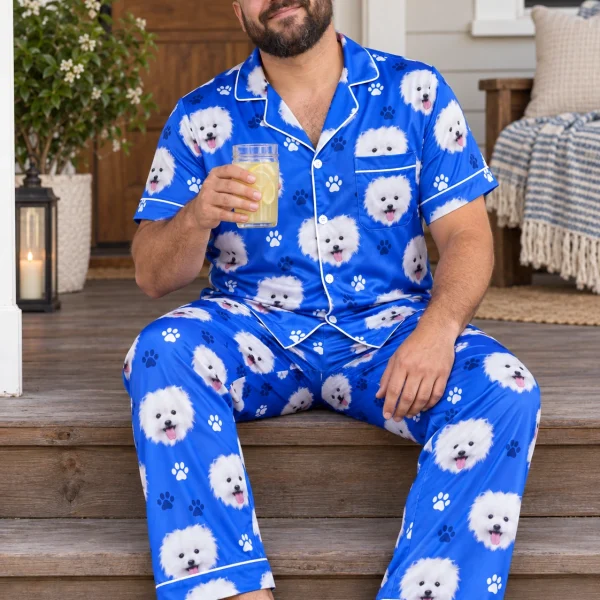 Man sitting in couples Christmas pajamas covered in white Pomeranian faces — MyDogPics