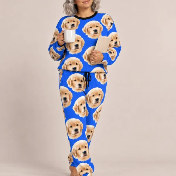 Woman wearing cozy pajamas covered in golden retriever puppy faces on royal blue fabric — MyDogPics