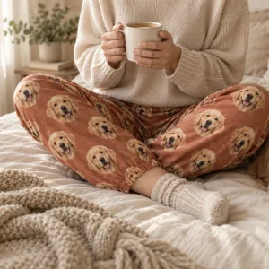 Custom pajama pants worn on a bed, printed with a golden retriever's face — MyDogPics
