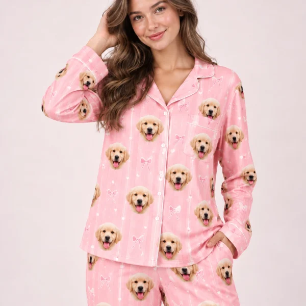 Close-up of the custom satin pajamas print: golden retriever puppy faces on pink satin with small bows — MyDogPics