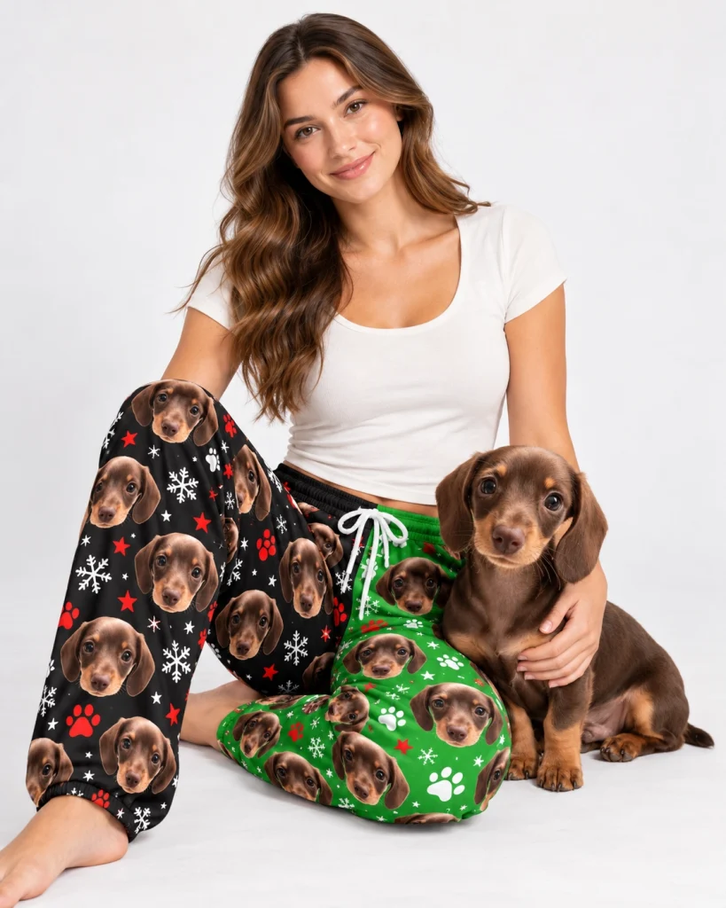 Woman in dachshund pajama pants cuddling her dachshund puppy — MyDogPics