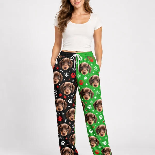 Woman wearing dachshund pajama pants covered in dachshund faces on a black and green snowflake print — MyDogPics