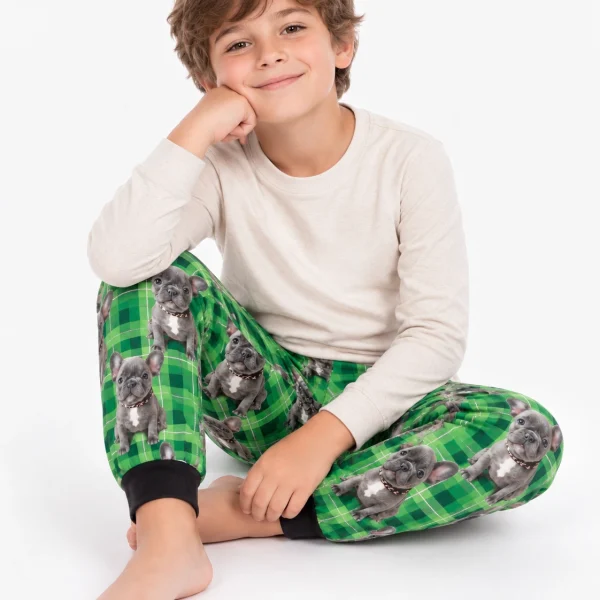 Boy sitting in a dog pajamas for kids covered in grey French bulldog faces — MyDogPics