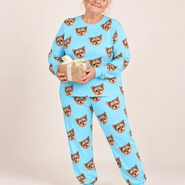 Woman wearing fall pajamas covered in Yorkshire terrier faces on light blue fabric — MyDogPics
