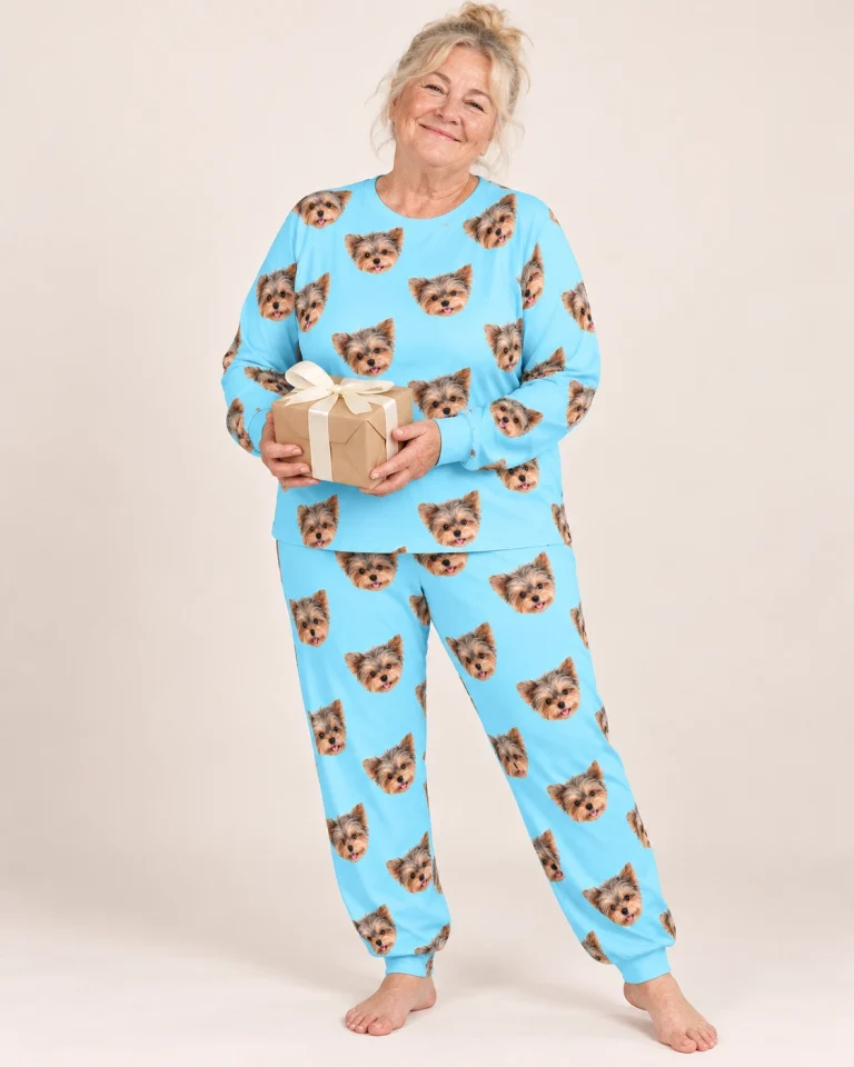 Woman wearing fall pajamas covered in Yorkshire terrier faces on light blue fabric — MyDogPics