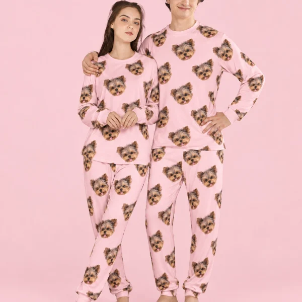 Couple wearing family matching pajamas covered in Yorkshire terrier faces on light pink fabric — MyDogPics