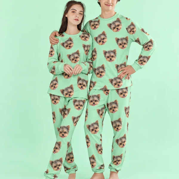Couple wearing family matching pajamas covered in Yorkshire terrier faces on mint green fabric — MyDogPics