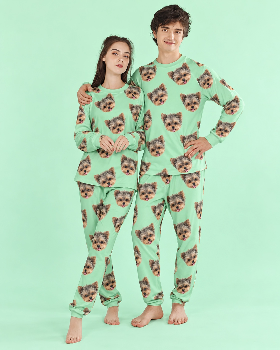 Family Matching Pajamas – Front View, Mint Green | MyDogPics Couple wearing family matching pajamas covered in Yorkshire terrier faces on mint green fabric — MyDogPics