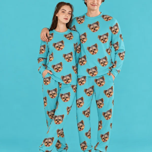 Couple wearing family matching pajamas covered in Yorkshire terrier faces on teal fabric — MyDogPics