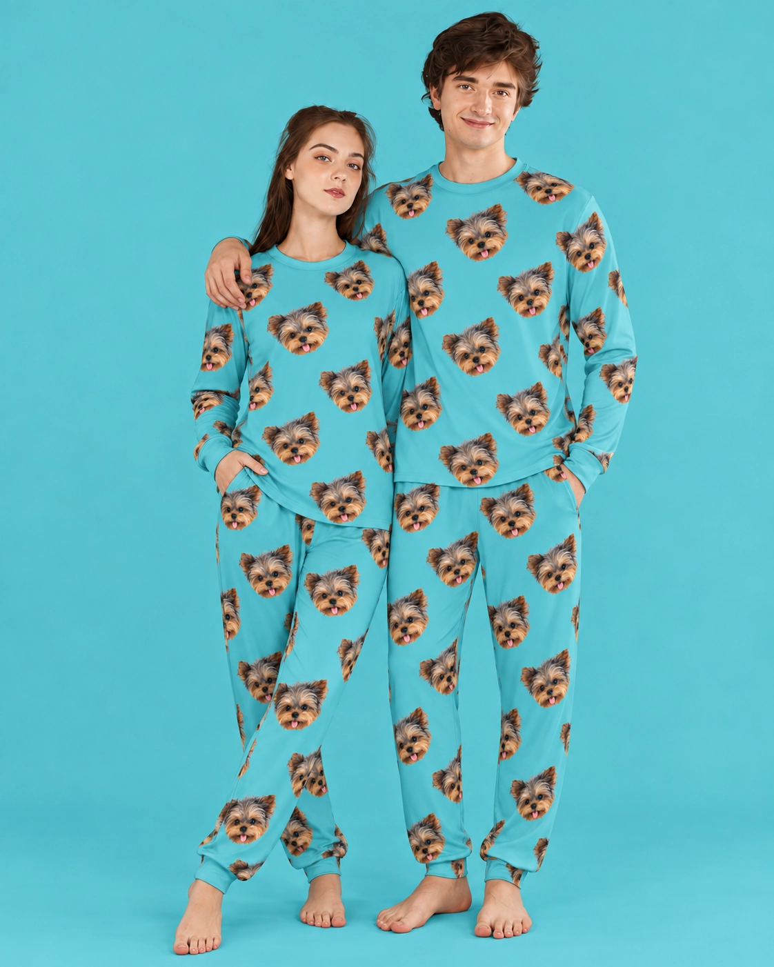 Family Matching Pajamas – Front View, Teal | MyDogPics Couple wearing family matching pajamas covered in Yorkshire terrier faces on teal fabric — MyDogPics