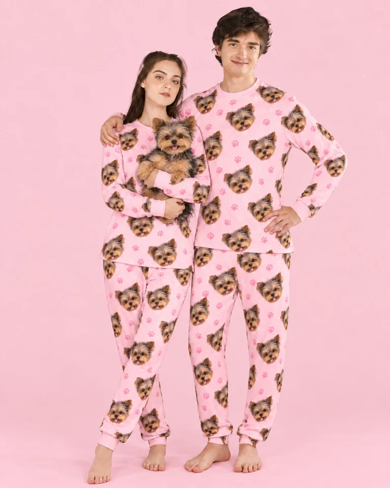 Couple in family matching pajamas holding their Yorkshire terrier — MyDogPics