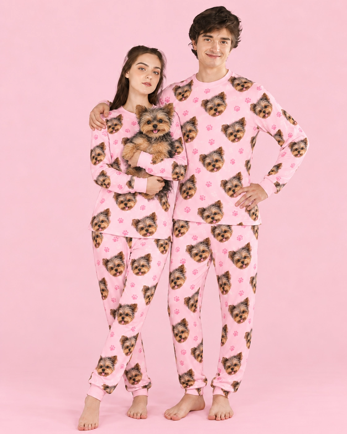 Family Matching Pajamas – Holding Dog, Blush Pink Paw-Print | MyDogPics Couple in family matching pajamas holding their Yorkshire terrier — MyDogPics