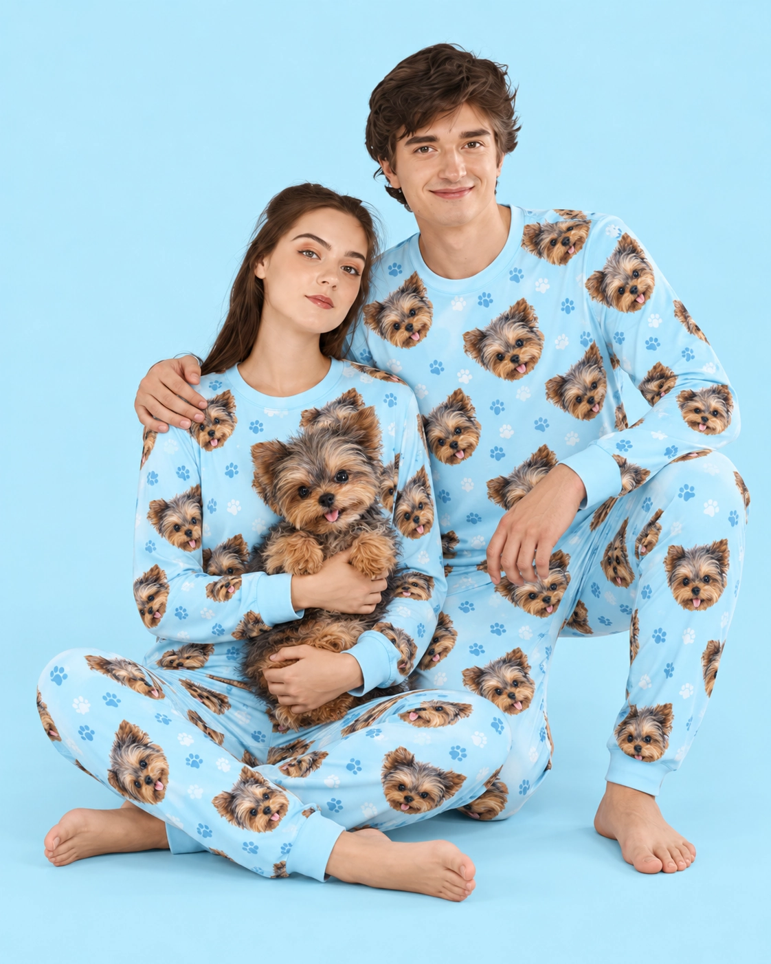 Family Matching Pajamas – Holding Dog, Light Blue Paw-Print | MyDogPics Couple in family matching pajamas holding their Yorkshire terrier — MyDogPics
