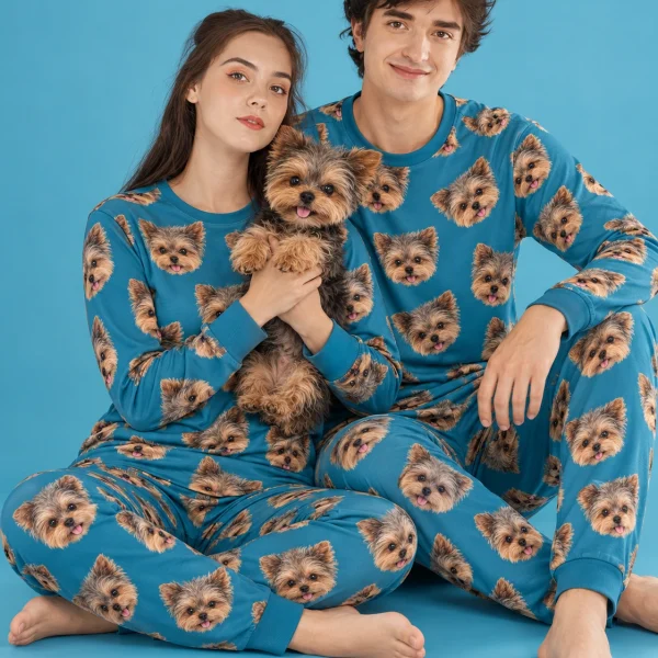 Couple in family matching pajamas holding their Yorkshire terrier — MyDogPics