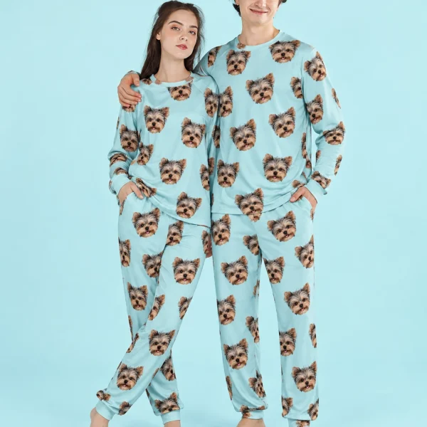 Couple posing in family matching pajamas, Yorkshire terrier faces on aqua fabric — MyDogPics