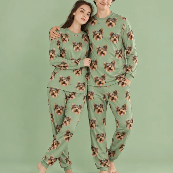 Couple posing in family matching pajamas, Yorkshire terrier faces on sage green fabric — MyDogPics