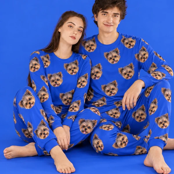 Couple sitting in family matching pajamas covered in Yorkshire terrier faces — MyDogPics
