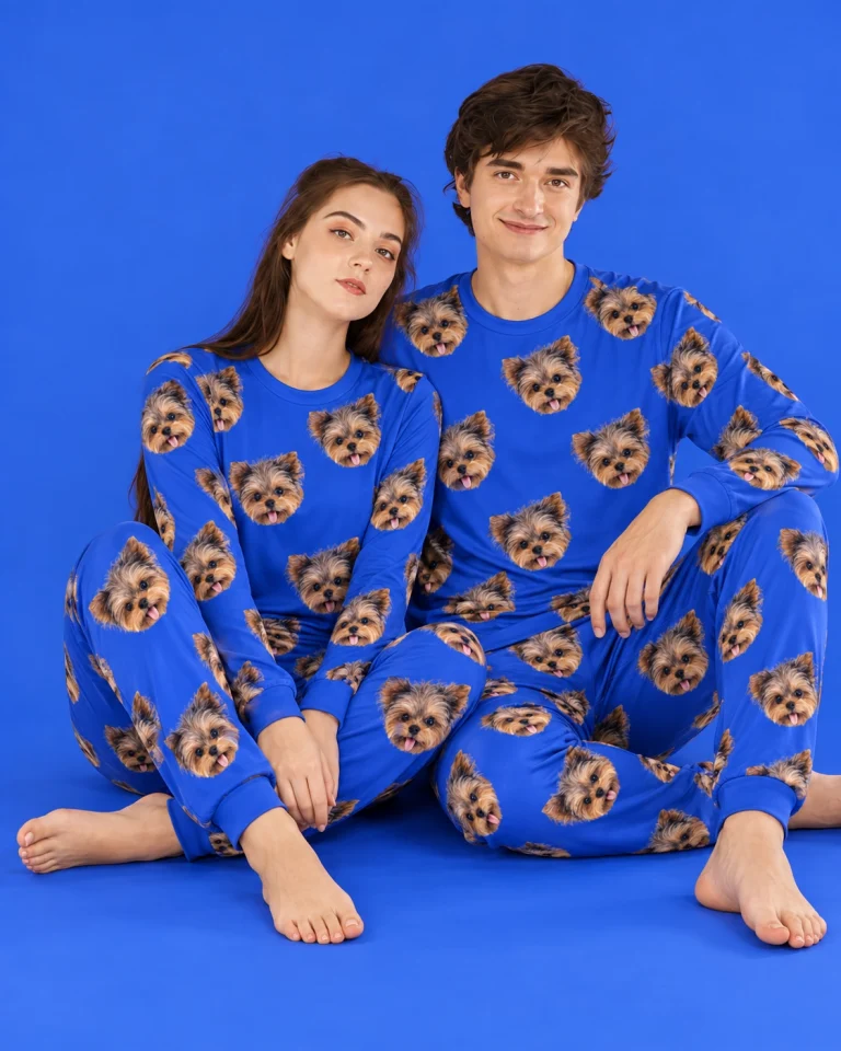 Couple sitting in family matching pajamas covered in Yorkshire terrier faces — MyDogPics