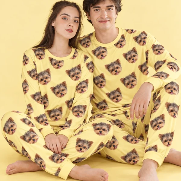 Couple sitting in family matching pajamas covered in Yorkshire terrier faces — MyDogPics
