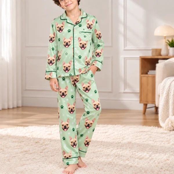 Boy posing in French bulldog jammies, fawn French bulldog faces on sage green satin with paw prints — MyDogPics
