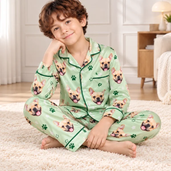 Boy sitting in French bulldog jammies covered in fawn French bulldog faces — MyDogPics