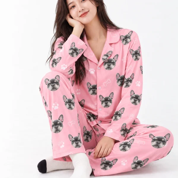 Woman sitting in French bulldog pajamas covered in grey French bulldog faces — MyDogPics
