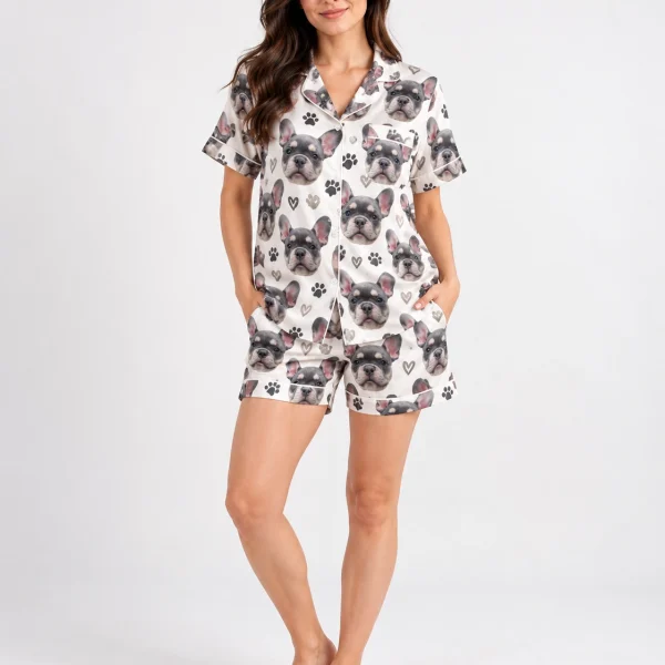 Woman wearing frenchie pajamas covered in grey French bulldog faces on ivory satin with black paw prints — MyDogPics