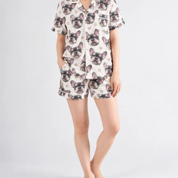 Woman wearing frenchie pajamas covered in grey French bulldog faces on ivory satin with black paw prints — MyDogPics