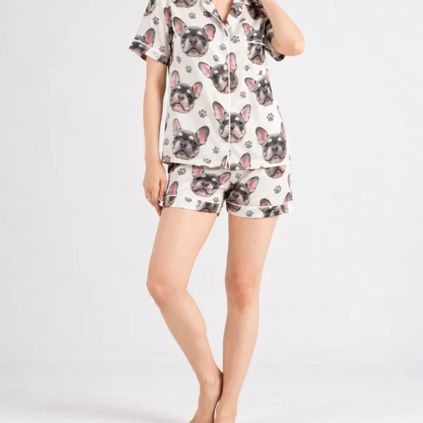 Woman posing in frenchie pajamas, grey French bulldog faces on ivory satin with black paw prints — MyDogPics