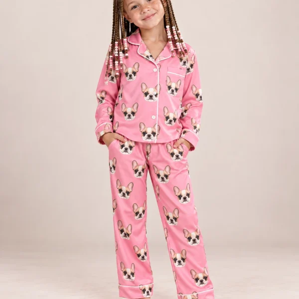 Girl wearing a girls pajama sets covered in cream French bulldog faces on pink satin — MyDogPics
