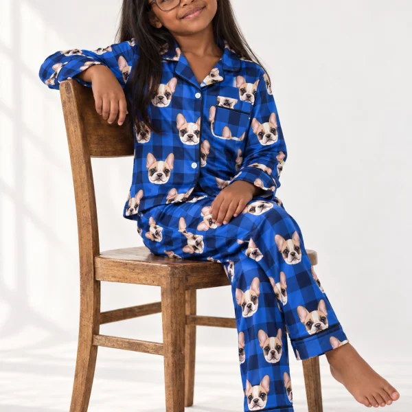 Girl sitting in a girls pajama sets covered in cream French bulldog faces — MyDogPics