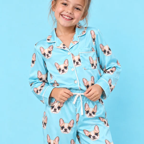 Close-up of the girls pajamas print: cream French bulldog faces on light blue satin — MyDogPics