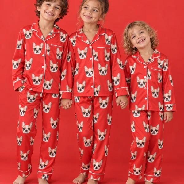 Kids in matching girls pajamas with cream French bulldog faces on red satin — MyDogPics