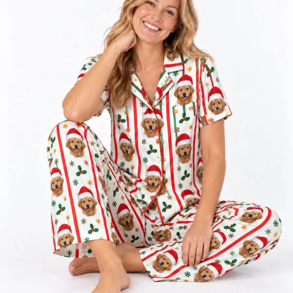 Woman sitting in golden retriever Christmas pajamas covered in golden retriever faces in Santa hats — MyDogPics