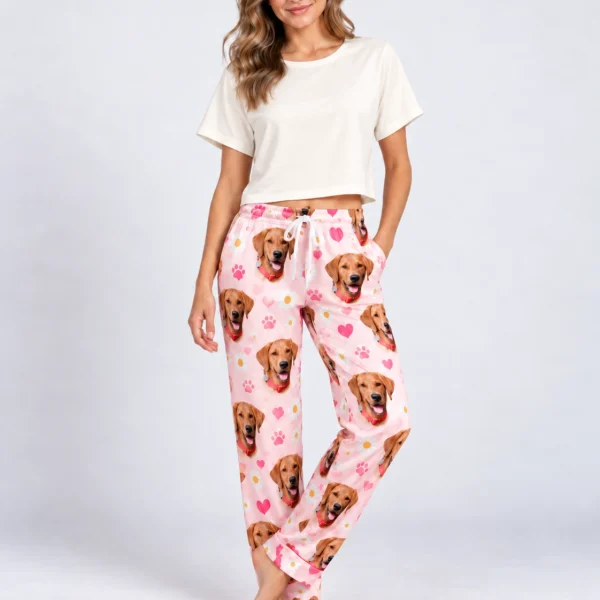 Woman posing in golden retriever pajama pants, golden retriever faces on a pink hearts and daisies print — MyDogPics