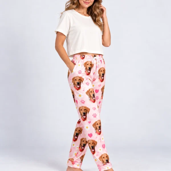 Woman posing in golden retriever pajama pants, golden retriever faces on a pink hearts and daisies print — MyDogPics
