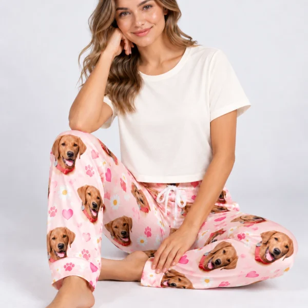 Woman sitting in golden retriever pajama pants covered in golden retriever faces — MyDogPics