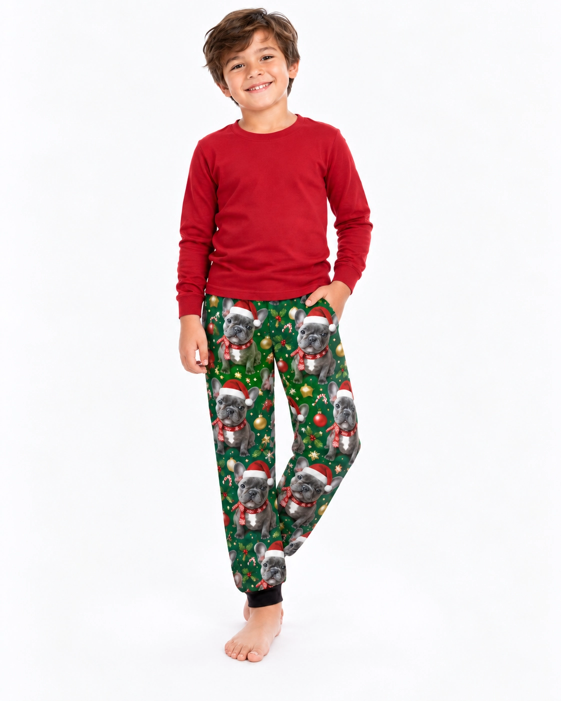 Kids Christmas Pajama Pants – Pose | MyDogPics Boy posing in kids Christmas pajama pants with French bulldog faces in Santa hats and scarves — MyDogPics